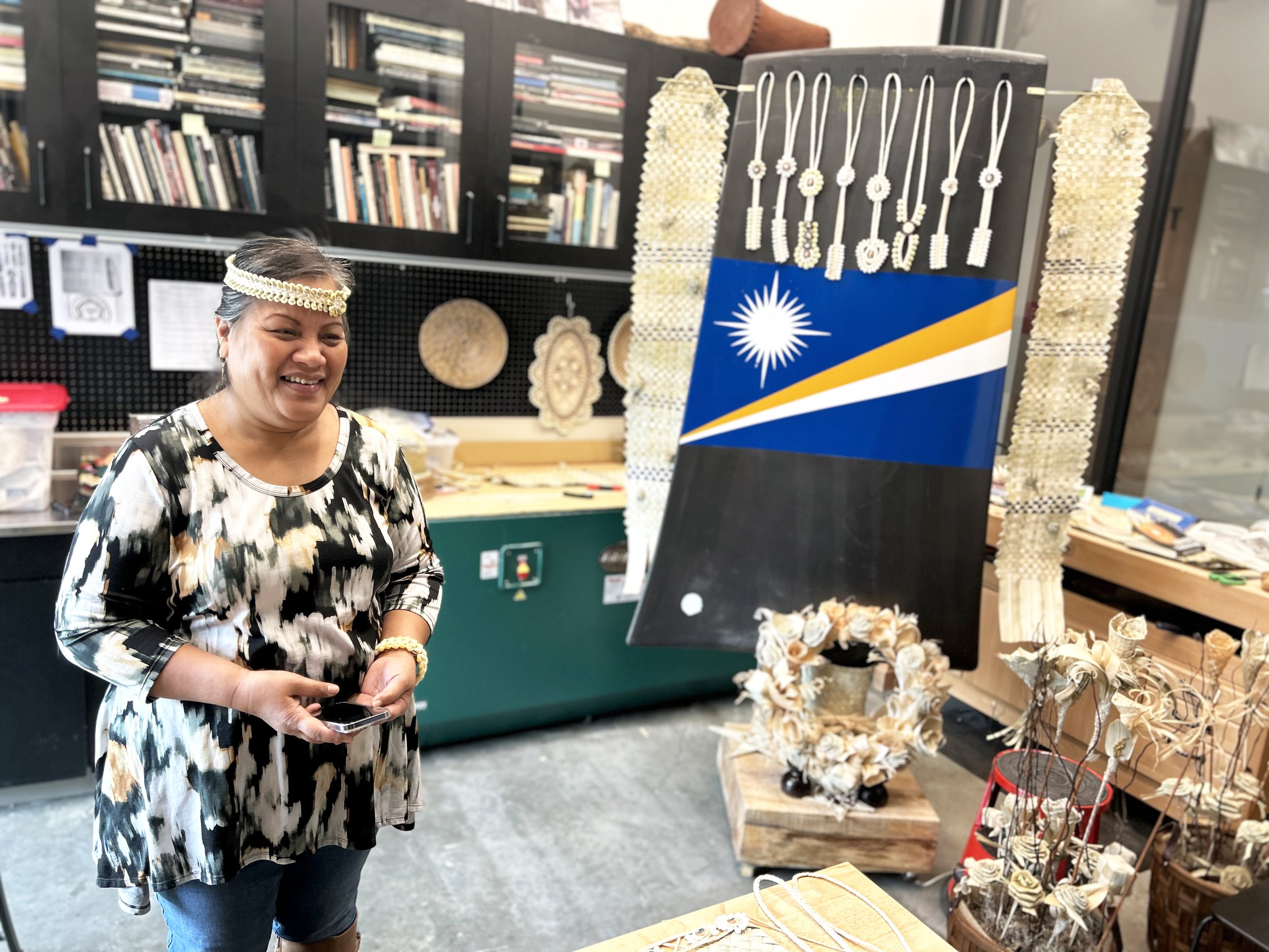 Emma Joran weaving pandanus on a nuclear fan blade at the Burke Museum
